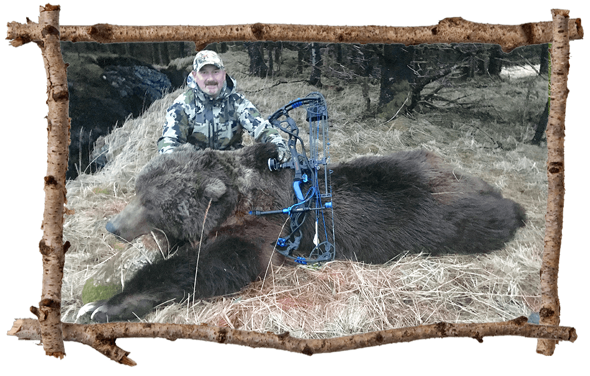 Hunter posing with bear