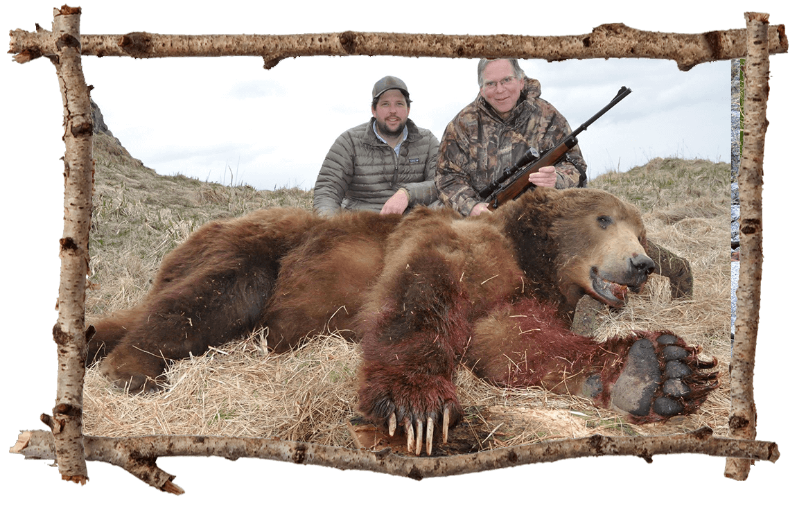 Hunter and guide posing with bear
