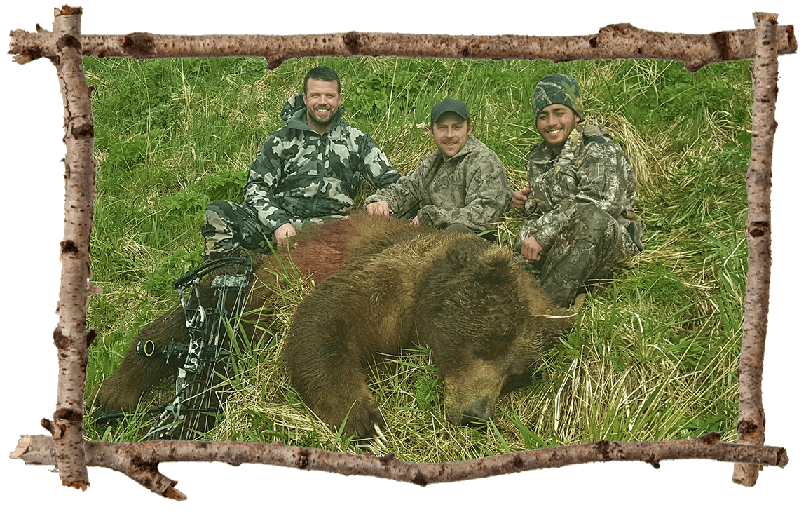 Three hunters posing with a bear