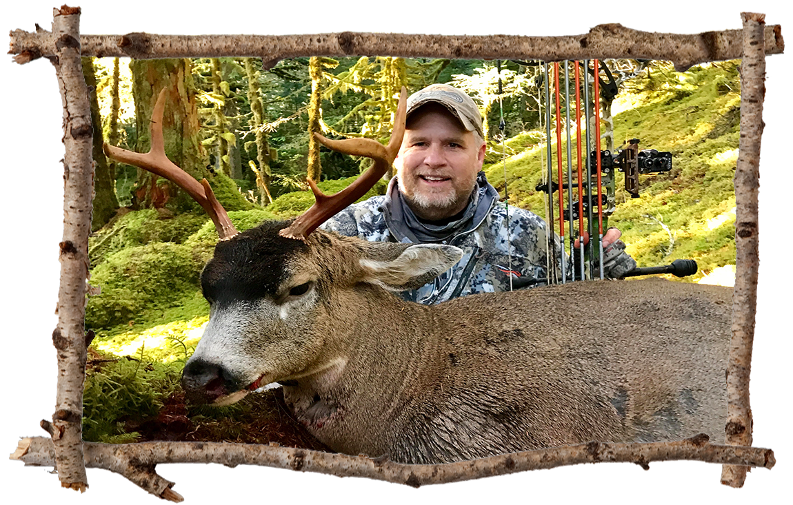 bow hunter posing with buck