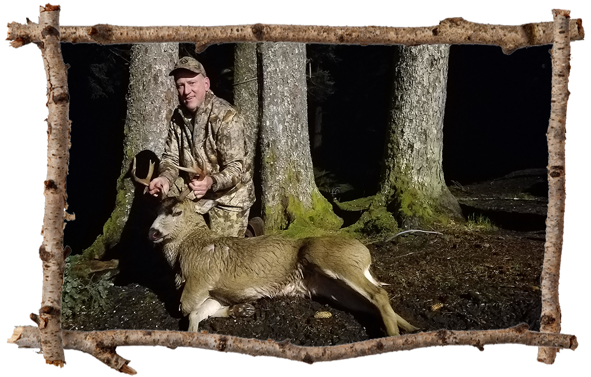 hunter holding a buck