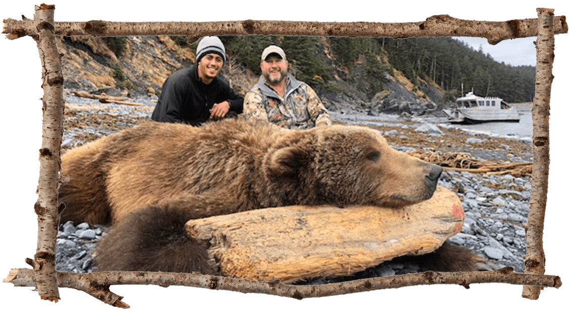 2 hunters with brown bear